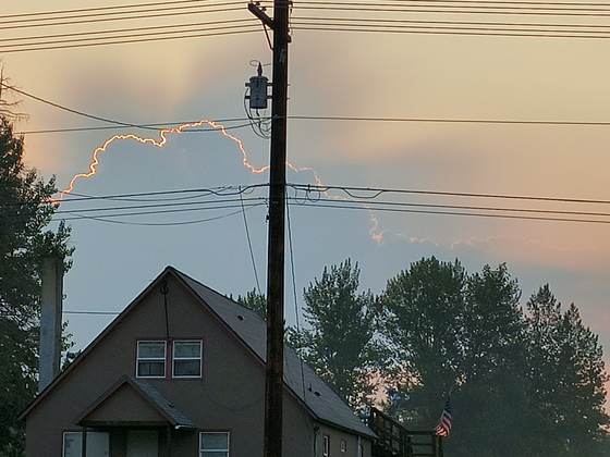 A home beneath power lines at sunset