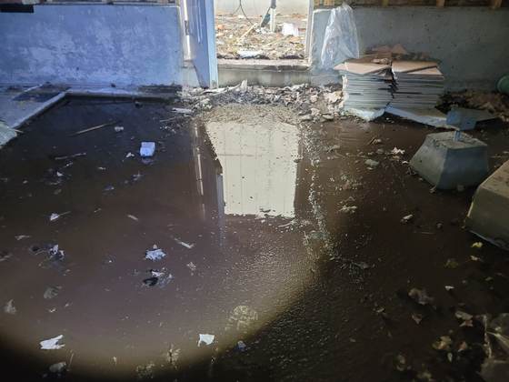 Standing water pooled on a crawlspace vapor barrier, a moisture issue documented