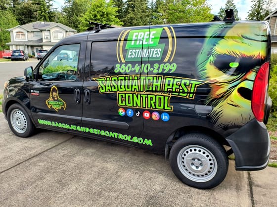 Side view of the wrapped Sasquatch Pest Control van showing the phone number, free estimates and web address