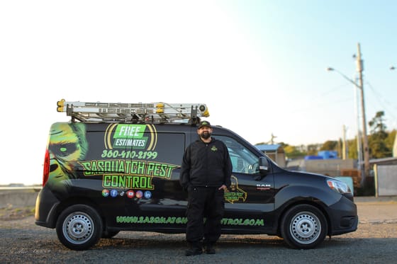 Tyson Elling standing beside the wrapped van at golden hour