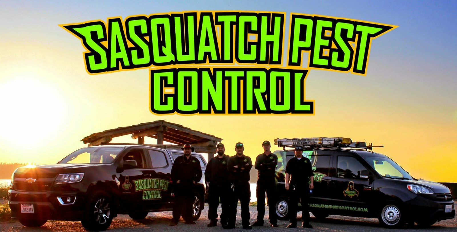 The Sasquatch Pest Control crew standing with two branded service vehicles at sunset