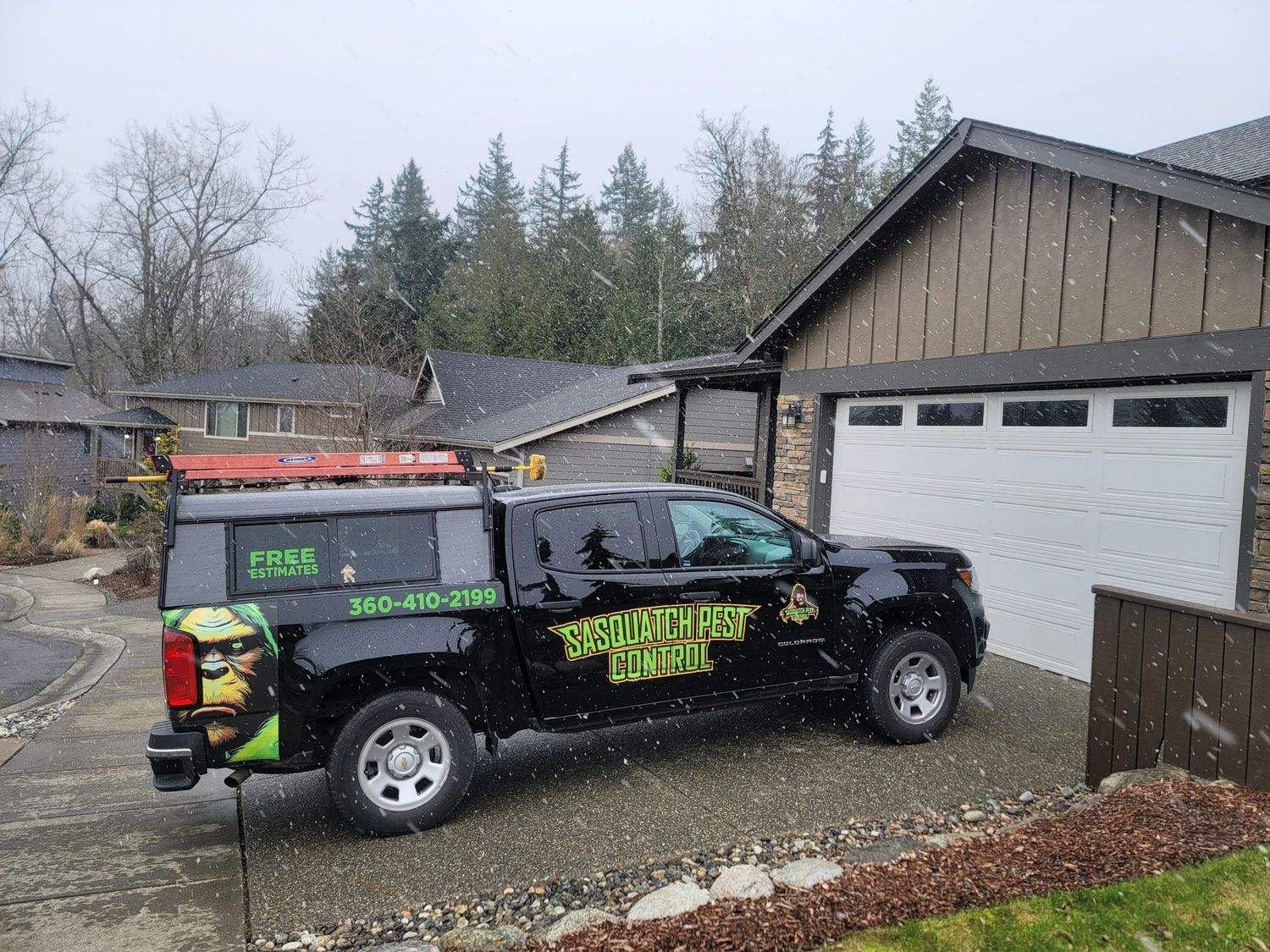 A wrapped Sasquatch Pest Control pickup truck parked on a driveway beside a garage during a service visit